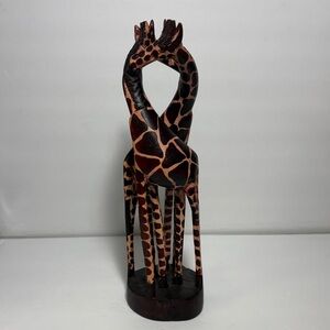 Giraffe wooden sculpture entwined neck symbolizing love or friendship